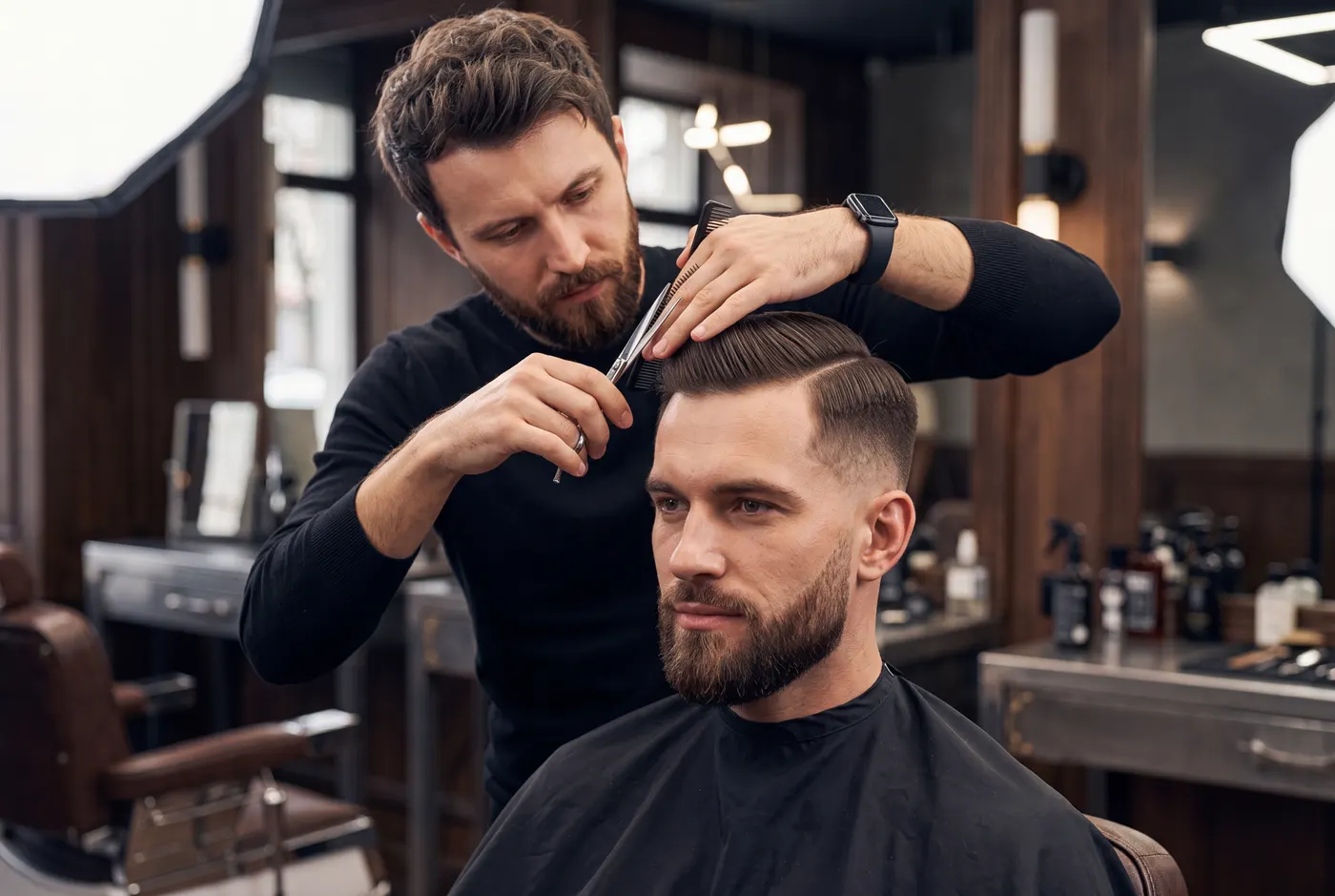 A barber cutting a customer's hair in a modern barbershop